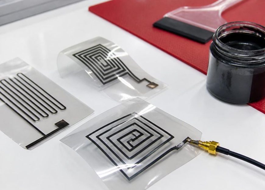 Printed black ink antenna patterns on clear film, connected to a coaxial test cable