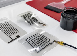 Printed black ink antenna patterns on clear film, connected to a coaxial test cable